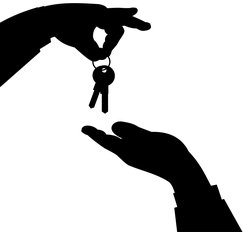 Hand giving keys to another hand